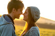 Romantic couple showing affection at sunset.