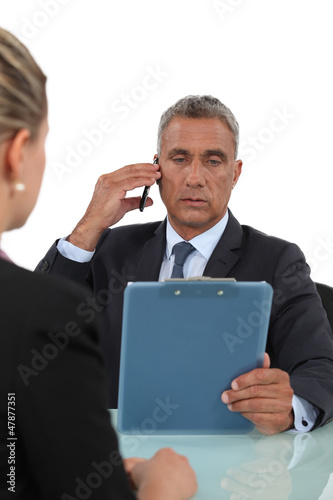 Photo: Boss checking colleague's work Boss checking colleague's work