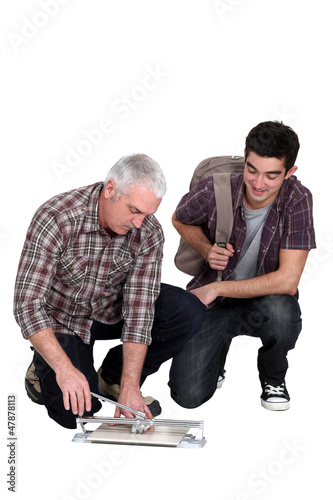 Photo: Tiler and apprentice Tiler and apprentice