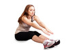 Photo: Young woman exercising touching toes Young woman exercising touching toes