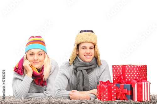 Photo: Couple lying on a carpet near presents Couple lying on a carpet near presents