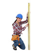 Woman measuring a piece of wood