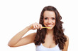 Young woman at home brushing teeth