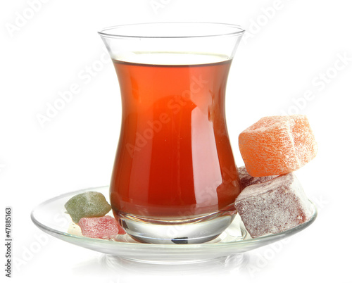 Photo: glass of Turkish tea and rahat Delight, isolated on white glass of Turkish tea and rahat Delight, isolated on white