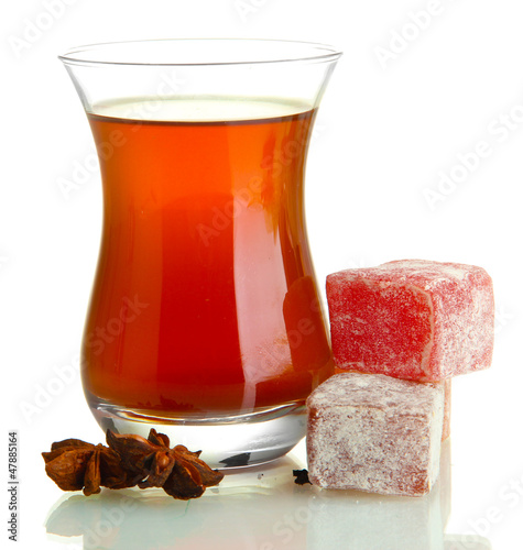 Photo: glass of Turkish tea and rahat Delight, isolated on white glass of Turkish tea and rahat Delight, isolated on white