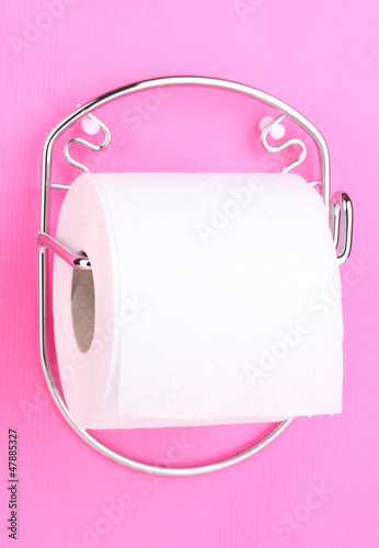 Photo: Roll of toilet paper on holder fixed to wall Roll of toilet paper on holder fixed to wall
