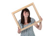 Brunette holding empty frame