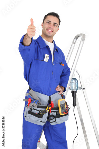 Photo: Handyman stood by equipment giving the thumbs-up Handyman stood by equipment giving the thumbs-up