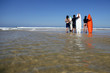 Three surfers waiting for big wave