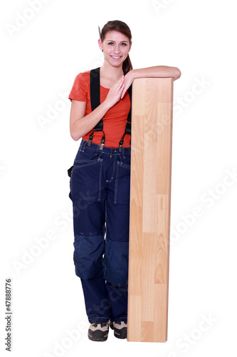 Photo: handywoman posing with a board handywoman posing with a board