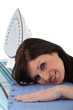 Foto: Woman laying her head on an ironing board Woman laying her head on an ironing board