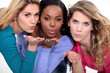 Three attractive women blowing kisses