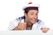 Man dressed in sailor costume with message board