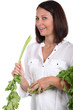 woman holding fresh parsley leaves