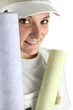 Decorator holding rolls of wallpaper
