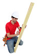 A carpenter using a plane.