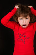 little girl shouting with arms to head
