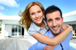 Happy new property owners in front of their house