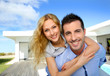 Happy new property owners in front of their house