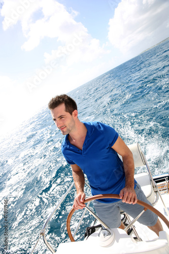 Photo: Young man sailing in caribbean sea Young man sailing in caribbean sea