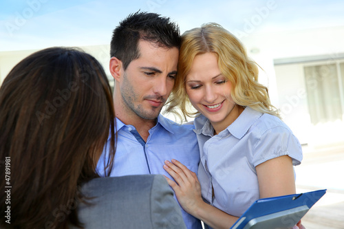 Photo: Young couple visiting luxury house for vacation Young couple visiting luxury house for vacation