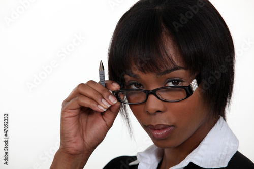 Photo: Woman seductively removing glasses Woman seductively removing glasses