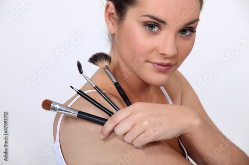 Photo: beautiful woman holding make up brushes beautiful woman holding make up brushes