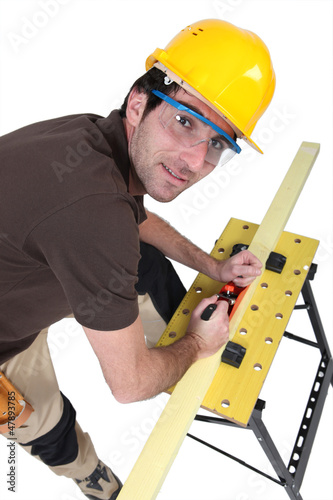 Photo: Woodworker using plane Woodworker using plane