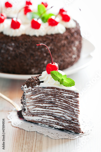 Photo: Piece of chocolate crepe cake with whipped cream and cherries Piece of chocolate crepe cake with whipped cream and cherries
