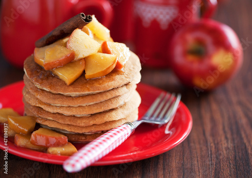 Photo: Pancakes with cinnamon and caramelized apples, selective focus Pancakes with cinnamon and caramelized apples, selective focus