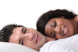 Young couple lying in bed