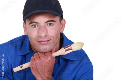 Photo: Man holding paint brush Man holding paint brush