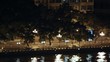 Cars go along embankment of Pearl river at night in light of