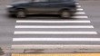 Cars quickly go on pedestrian crossing near sidewalk