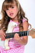 Little girl playing electric guitar