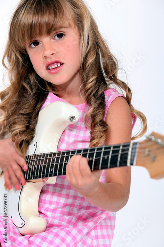 Photo: Little girl playing electric guitar Little girl playing electric guitar
