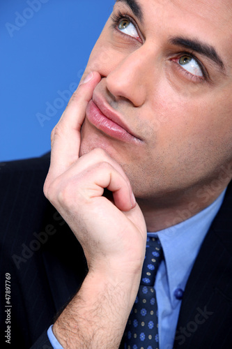 Photo: Close-up shot of a pensive businessman Close-up shot of a pensive businessman