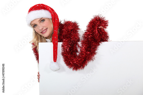 Photo: Festive woman stood with blank poster Festive woman stood with blank poster