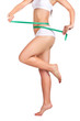 sexy sporty woman's body and measuring tape