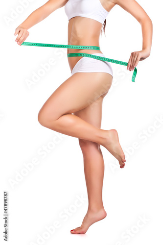 Photo: sexy sporty woman's body and measuring tape sexy sporty woman's body and measuring tape
