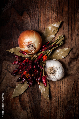 Photo: composition of chilies, onion and garlic composition of chilies, onion and garlic