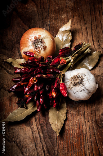 Photo: composition of chilies, onion and garlic composition of chilies, onion and garlic