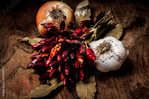 Photo: composition of chilies, onion and garlic composition of chilies, onion and garlic