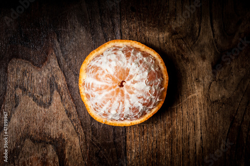 Photo: peeled mandarin with leaf on wood peeled mandarin with leaf on wood