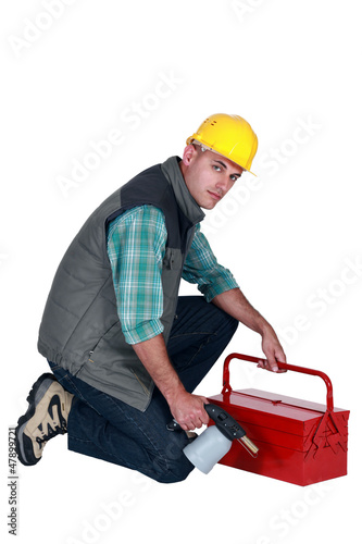 Photo: Workman with a blowtorch and toolbox Workman with a blowtorch and toolbox