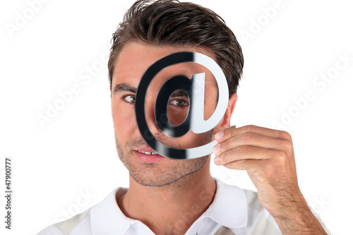 Photo: Man holding at symbol Man holding at symbol
