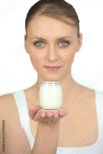 Photo: woman holding an yoghourt woman holding an yoghourt