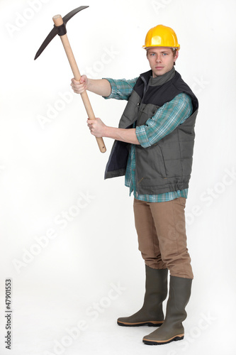 Photo: Man holding pick axe Man holding pick axe