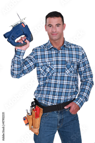 Photo: Man with an electric jigsaw Man with an electric jigsaw