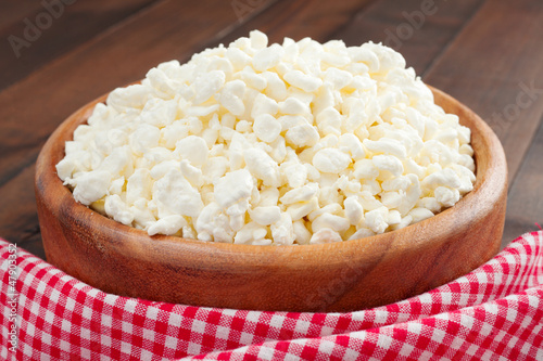 Photo: cottage cheese in rustic wooden plate cottage cheese in rustic wooden plate